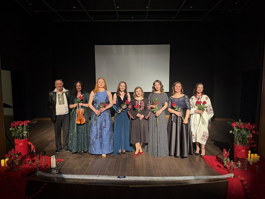 Ensemble cast photo on stage after a performance